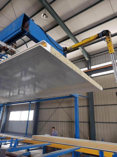 PU sandwich panel being lifted by crane during production